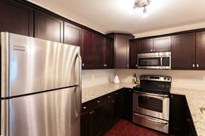 Saint John townhouse for rent - A kitchen with a stainless steel refrigerator and a stainless steel oven.