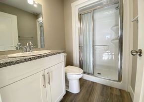 Saint John townhouse for rent - A bathroom with a toilet, sink, and shower.