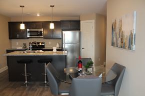 Saint John townhouse for rent - A kitchen with a bar and chairs.