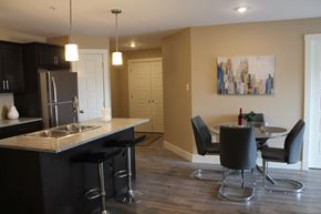 Saint John townhouse for rent - A kitchen with black cabinets and a black bar stool.