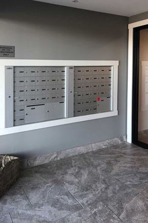 Saint John townhouse for rent - A wall of mailboxes is on the side of a building.