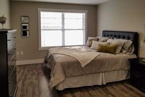 Saint John townhouse for rent - A bedroom with a large bed and a window.