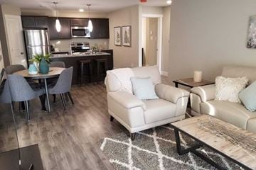 Saint John townhouse for rent - A modern living room with a dining table and chairs.
