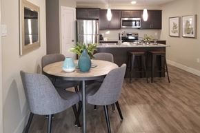 Saint John townhouse for rent - A kitchen with a table and chairs in the foreground.