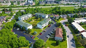 Gatineau apartment for rent - A bird's eye view of a residential area with houses and a parking lot.