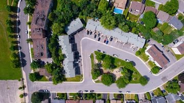 Gatineau townhouse for rent - A bird's eye view of a residential area with houses, trees, and roads.