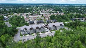 Gatineau townhouse for rent - A bird's eye view of a residential area with apartment buildings surrounded by trees.