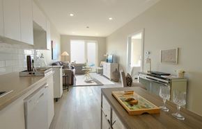 Saint John townhouse for rent - A modern kitchen with a wooden table and a tray of food on it.