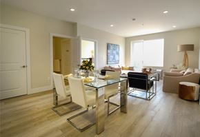 Saint John townhouse for rent - A modern dining room with a glass table and chairs.