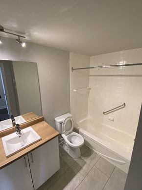 Gatineau townhouse for rent - A white bathroom with a toilet, sink, and bathtub.