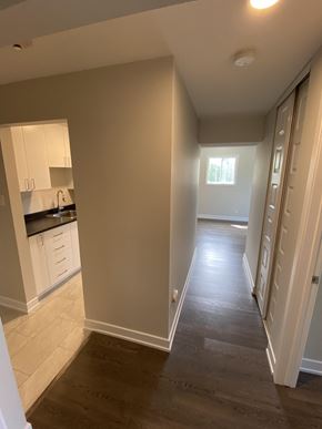 Gatineau townhouse for rent - A kitchen with white cabinets and a window.