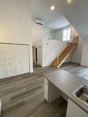 Gatineau townhouse for rent - A kitchen with a sink and a staircase in the background.