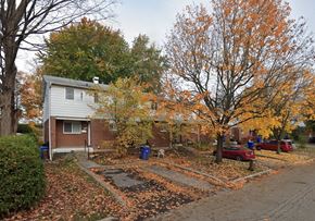 Gatineau apartment for rent - A house with a driveway and trees with orange leaves.