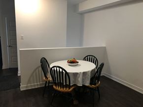 Embrun apartment for rent - A table with a white cloth and a bowl of fruit on it is surrounded by four chairs.
