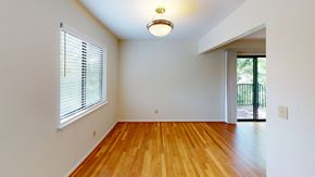 Kansas City apartment for rent - an empty living room with wood floors and a large window