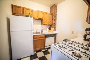 Kansas City apartment for rent - a kitchen with a stove and refrigerator and a sink