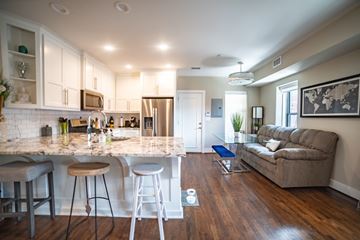 Kansa City apartment for rent - A kitchen with a bar area and a couch in the living room.