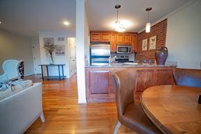 Kansas City apartment for rent - A kitchen with a table and chairs in the foreground and a refrigerator in the background.