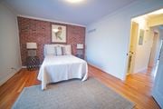 Kansas City apartment for rent - a bedroom with a bed and a brick wall