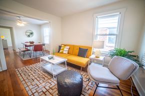 Kansas City apartment for rent - a living room with a yellow couch and a dining room table