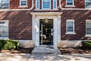 Kansas City apartment for rent - A red brick building with a black door and windows.