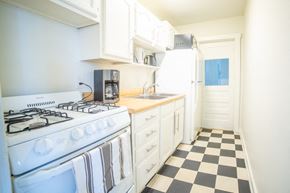 Kansas City apartment for rent - a kitchen with white appliances and a checkered floor