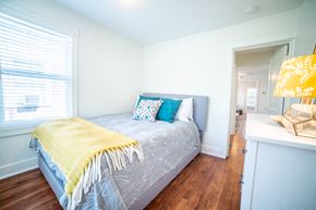 Kansas City apartment for rent - a bedroom with a bed with a yellow blanket and pillows