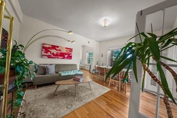Kansas City apartment for rent - A living room with a grey couch and a red and white painting on the wall.