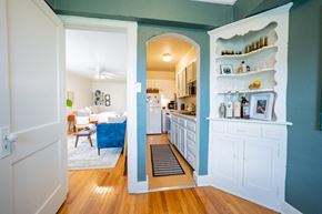 Kansas City apartment for rent - A kitchen with a blue wall and white cabinets.
