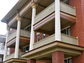 Kansas City apartment for rent - a red brick building with a balcony and columns