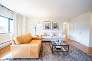 Kansas City apartment for rent - A living room with a tan couch and a white couch.