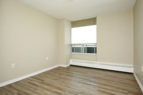Oshawa apartment for rent - A room with wooden flooring and a window.