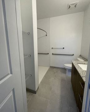 West Palm Beach apartment for rent - A white bathroom with a toilet and a walk in shower.