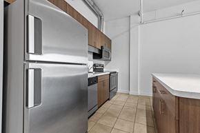 Southfield apartment for rent - a kitchen with stainless steel appliances and wooden cabinets at Arbor Lofts, Southfield