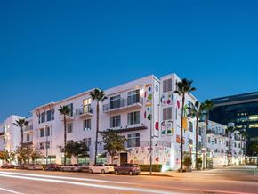 North Hollywood apartment for rent - a city at night with cars parked in front of a building