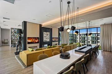 Los Angeles apartment for rent - A modern living room with a white dining table and yellow and brown sofas.