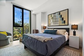 Los Angeles apartment for rent - A bedroom with a large bed and a painting on the wall.