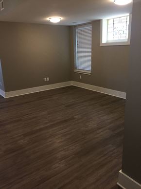 St. Louis apartment for rent - A room with wooden flooring and a window with blinds.