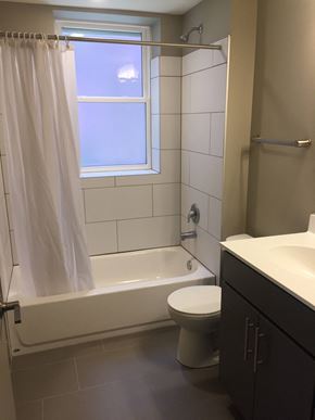 St. Louis apartment for rent - a bathroom with a toilet and a tub and a window