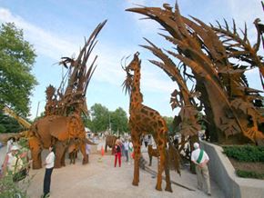 University City apartment for rent - a group of people standing around a giraffe exhibit