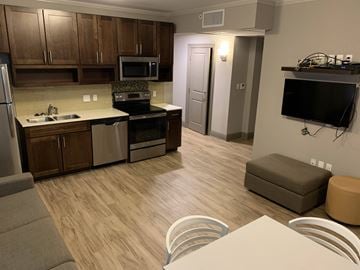 University apartment for rent - a kitchen and living room with a table and chairs