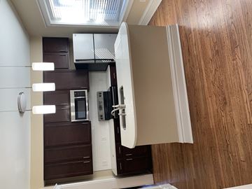St. Louis apartment for rent - an open kitchen door with a refrigerator and a microwave