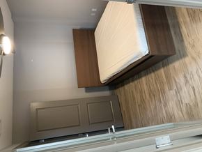 University apartment for rent - a window in a bathroom with a wooden wall and a mirror