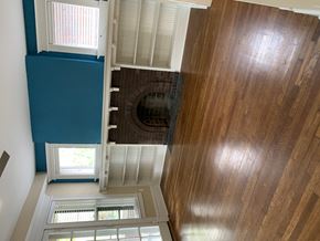 Saint Louis apartment for rent - the view from the top of the stairs looking down into the hallway of a house
