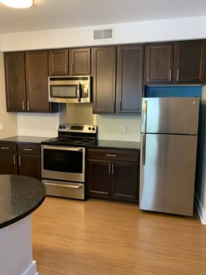 Saint Louis apartment for rent - a kitchen with stainless steel appliances and dark wood cabinets