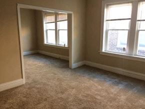St. Louis apartment for rent - an empty room with two windows and a carpet