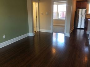 University City apartment for rent - an empty living room with wooden floors and a refrigerator
