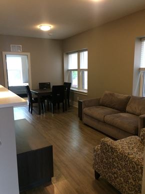 St. Louis apartment for rent - an open living room and dining room with a couch and a table