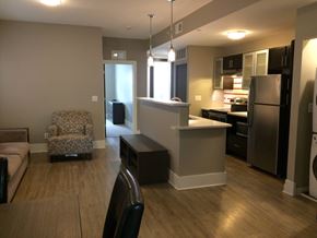St. Louis apartment for rent - an open kitchen and living room with a table and a chair