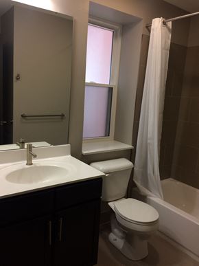 St. Louis apartment for rent - A white toilet sits next to a sink in a bathroom.
